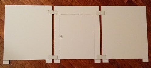 Materials used to build the cat litter box stall, white cardboard.