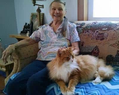 Rose and her cat Fluffy sitting on a couch together.